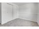 Bedroom featuring neutral carpet, closet with sliding doors, and white walls at 433 S Vaughn Way, Aurora, CO 80012