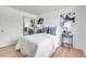 Comfortable bedroom with hardwood floors, white walls, and mirrored closet doors at 433 S Vaughn Way, Aurora, CO 80012