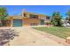 Side view of a two-story home with attached garage and driveway at 433 S Vaughn Way, Aurora, CO 80012