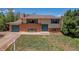 Charming two-story home featuring a brick facade and well-maintained lawn at 433 S Vaughn Way, Aurora, CO 80012