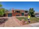Well-maintained two-story home with brick accents, attached garage, and manicured landscaping at 433 S Vaughn Way, Aurora, CO 80012