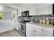 Charming kitchen features stainless steel appliances, mosaic backsplash, and ample counter space at 433 S Vaughn Way, Aurora, CO 80012