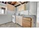 Basement kitchen featuring tile floors, standard appliances, and cabinetry for a functional space at 433 S Vaughn Way, Aurora, CO 80012