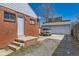 Back of house with long driveway and detached two-car garage at 1540 Zenobia St, Denver, CO 80204