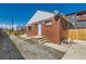 Exterior view of a brick home and gravel area at 1540 Zenobia St, Denver, CO 80204