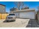 A two-car garage is shown with a vehicle parked in front of it on a sunny day at 1540 Zenobia St, Denver, CO 80204