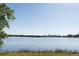 Scenic lake view with lush green trees in the background and a distant cityscape under a clear sky at 1540 Zenobia St, Denver, CO 80204