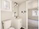 Clean bathroom with a single sink vanity, toilet and window at 1230 Peoria St, Aurora, CO 80011