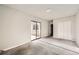 Bright bedroom with carpet flooring, neutral walls and sliding glass door access to patio at 1230 Peoria St, Aurora, CO 80011