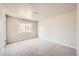 Simple bedroom with carpet flooring, neutral walls and a window at 1230 Peoria St, Aurora, CO 80011