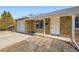 Front view of a ranch home with a white door and attached garage at 1230 Peoria St, Aurora, CO 80011