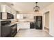 Updated kitchen with white cabinets, black appliances and wood floors at 1230 Peoria St, Aurora, CO 80011