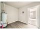 Unfinished laundry area with water heater and space for washer/dryer at 1230 Peoria St, Aurora, CO 80011