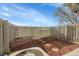Backyard featuring mulch and brick accents, enclosed by a wood fence at 1888 Oakcrest Cir, Castle Rock, CO 80104