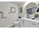 Clean and modern bathroom with a sleek vanity, round mirror, and contemporary fixtures at 1888 Oakcrest Cir, Castle Rock, CO 80104