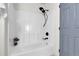 Clean bathroom featuring a bathtub with shower head, and modern fixtures at 1888 Oakcrest Cir, Castle Rock, CO 80104