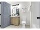 Stylish bathroom features a modern vanity, round mirror and patterned tile floor at 1888 Oakcrest Cir, Castle Rock, CO 80104