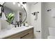 Bathroom featuring a modern vanity with a round mirror, stylish lighting, and decor at 1888 Oakcrest Cir, Castle Rock, CO 80104