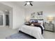 Bright bedroom features a ceiling fan, plush carpet and tasteful wall art at 1888 Oakcrest Cir, Castle Rock, CO 80104