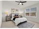 Comfortable bedroom features a ceiling fan, a large window and neutral decor at 1888 Oakcrest Cir, Castle Rock, CO 80104