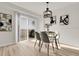 Elegant dining area with a modern chandelier and scenic views from the sliding glass doors at 1888 Oakcrest Cir, Castle Rock, CO 80104