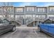 Charming townhome complex showcasing blue siding, private entrances, and well-maintained landscaping at 1888 Oakcrest Cir, Castle Rock, CO 80104