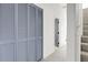 Hallway with closet featuring louvered doors and access to other rooms at 1888 Oakcrest Cir, Castle Rock, CO 80104