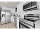 Contemporary kitchen featuring stainless steel appliances, white cabinetry, and modern fixtures at 1888 Oakcrest Cir, Castle Rock, CO 80104