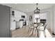 Modern kitchen featuring stainless steel appliances, sleek white cabinetry, and an adjacent dining area at 1888 Oakcrest Cir, Castle Rock, CO 80104