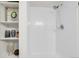 Bright shower with white tiled walls, silver hardware, and a shower head with hose at 1888 Oakcrest Cir, Castle Rock, CO 80104
