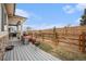 Backyard with a partially covered patio and wood fence at 5331 Routt Ct, Arvada, CO 80002