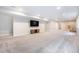 The expansive finished basement features plush carpet and a mounted TV creating a cozy and versatile living space at 5331 Routt Ct, Arvada, CO 80002
