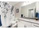 Neutral bathroom with a vanity, large mirror, and gray accents, creating a serene and calming space at 5331 Routt Ct, Arvada, CO 80002