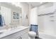 Well-lit bathroom with modern fixtures, a tub with shower, and a vanity, offering a clean and functional design at 5331 Routt Ct, Arvada, CO 80002