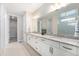 Elegant bathroom with a double vanity, granite countertop, and modern fixtures at 5331 Routt Ct, Arvada, CO 80002