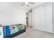 Cozy bedroom with carpeted floors, closet, and view of hallway at 5331 Routt Ct, Arvada, CO 80002