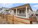 Charming covered patio with comfortable seating and view of the fenced backyard at 5331 Routt Ct, Arvada, CO 80002
