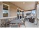Spacious covered patio with stylish furniture, stone accents, and backyard view at 5331 Routt Ct, Arvada, CO 80002