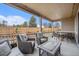 Relaxing covered patio featuring comfortable seating, string lights, and view of the backyard at 5331 Routt Ct, Arvada, CO 80002