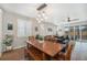 Dining area with a large wooden table, bench seating, and sliding glass doors to the backyard at 5331 Routt Ct, Arvada, CO 80002