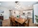 Dining area with a wooden table, open to the kitchen, and a view of the backyard at 5331 Routt Ct, Arvada, CO 80002