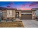Charming single-Gathering home featuring stone accents, two-car garage, and a cozy front porch at 5331 Routt Ct, Arvada, CO 80002