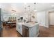Spacious kitchen featuring an island with a sink and dishwasher, open to the dining and living areas at 5331 Routt Ct, Arvada, CO 80002