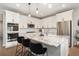 Bright kitchen with white cabinets, granite countertops, stainless steel appliances, and a center island at 5331 Routt Ct, Arvada, CO 80002