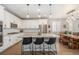 Open kitchen layout featuring a large island with seating and modern appliances, flowing into the dining area at 5331 Routt Ct, Arvada, CO 80002