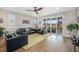 Cozy living room with leather furniture, hardwood floors, and a sliding glass door to the deck at 5331 Routt Ct, Arvada, CO 80002
