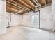 Unfinished basement with white insulation, concrete floor, and small window at 5331 Routt Ct, Arvada, CO 80002