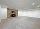 A spacious, carpeted basement with a stone fireplace and mantle at 12925 Sierra Cir, Parker, CO 80138