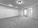 Finished basement with walk-out door to the outside, featuring neutral carpet at 12925 Sierra Cir, Parker, CO 80138