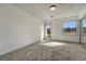 A bright, carpeted bedroom with a window and door letting in natural light at 12925 Sierra Cir, Parker, CO 80138